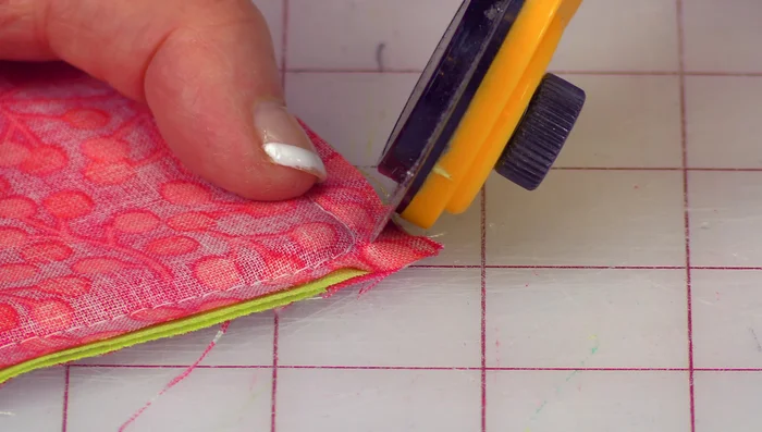Trim the corners of the fabric, being careful not to cut into the stitching.