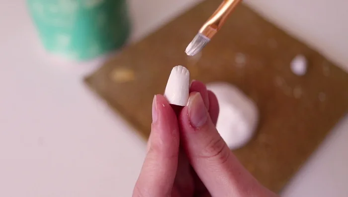 Spraying with varnish to create a smoother surface.