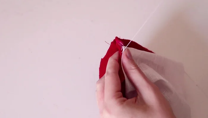 Gathering and sewing the white fabric to create the inner lining of the hat.