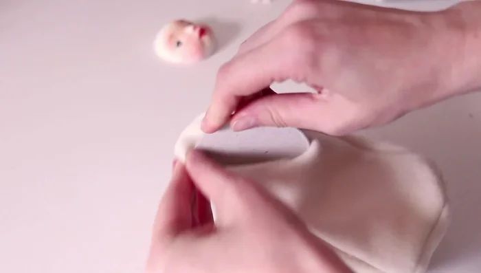 Stuffing the doll body.