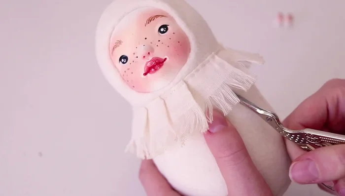 Attaching the hands to the doll body with super glue.