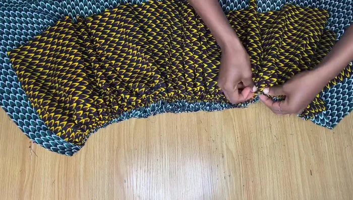 Assemble the skirt. Pin the gathered shorter piece onto the gathered longer piece, aligning the raw edges. Sew together.