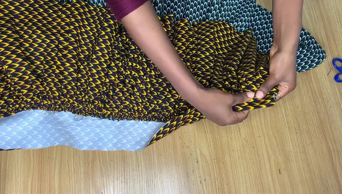 Finish the waistband. Fold the raw edge of the waistband over to the inside and stitch, creating a neat finish and hiding the stitching. Repeat for the top of the skirt.