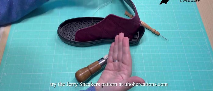 Begin stitching. Mimic a sewing machine by using the awl to create lock stitches. Maintain tension on both the upper and lower threads. Keep your finger on the reel to control thread feed. 