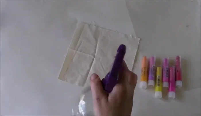 Prepare fabric for painting by lightly spraying with water.