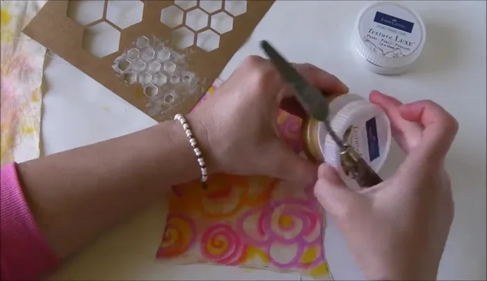 Apply gold textured tool to one corner using stencils for added detail.