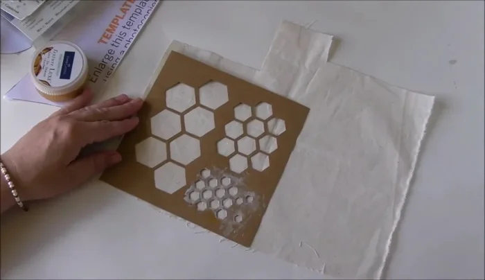 Prepare fabric for painting by lightly spraying with water.