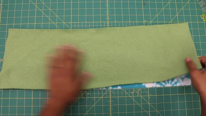 Sew along the two long edges using a narrow zig-zag stitch (width 1.5, length 3.0). Use an 80/12 universal needle or a 90/14 needle if needed, and polyester thread.