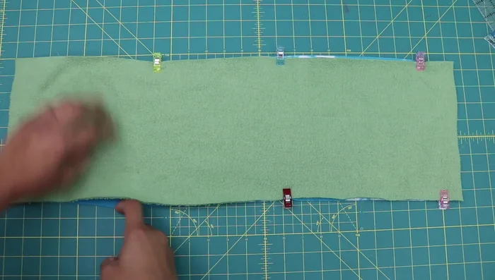Sew along the two long edges using a narrow zig-zag stitch (width 1.5, length 3.0). Use an 80/12 universal needle or a 90/14 needle if needed, and polyester thread.