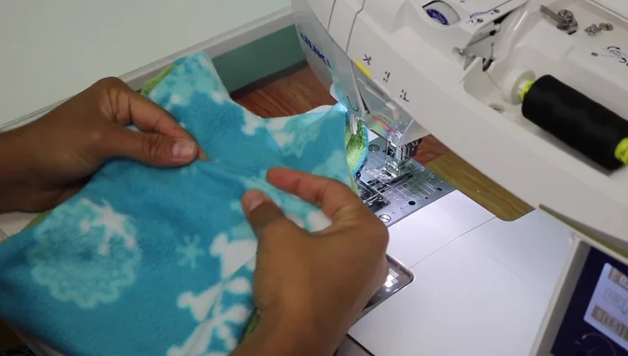 Close the opening using a ladder stitch by hand, hiding the knot inside the seam allowance. Use thread that matches the fabric color.