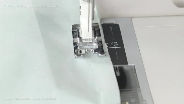 Sew your garment. Use a sharp needle (size 70/10) and all-purpose or silk thread (300.759). Leave the tissue paper attached during sewing for easier feeding (314.96). Use short stitch lengths and tie knots by hand (338).