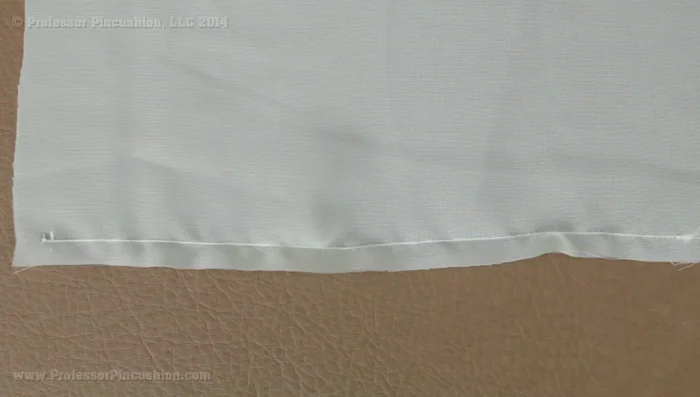 Hem your garment. For a delicate hem, use a rolled hem technique (530.76). Stitch an ⅛ inch from the edge, fold to the wrong side, press, trim excess fabric, fold again, and stitch along the top.