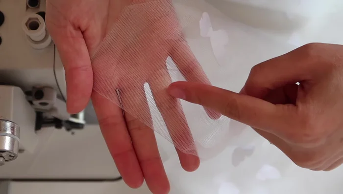 Sew along the folded edge of the tulle (about 3 centimeters wide) to create a casing for the elastic. Use a straight stitch if using a sewing machine, or a running stitch by hand. If using a sewing machine and joining multiple tulle pieces, sandwich the new piece over the old, keeping folded edges aligned, and continue sewing.