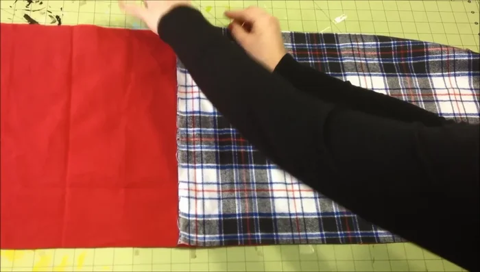 Sew the two pieces of flannel together along both the front and back sides, stopping before the fringe section.