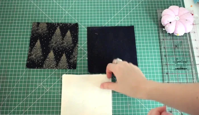 Layer the fabrics: Place one fabric piece right side down, then place the wadding on top, followed by the second fabric piece right side down.