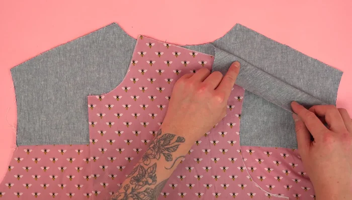 Attach front panels to back panel, press seams, and topstitch.