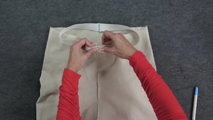 Zigzag stitch the elastic to the fabric, stretching the elastic as you sew. (1.4 length, 3.5 width)