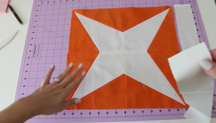 Quarter your quilt top and border fabric using finger pressing or other methods to mark the center and quarter points.