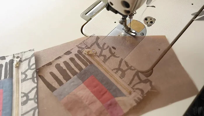 Create rolled hem and attach to pouch: Sew a rolled hem along the top edge of the pouch, then attach it to the back part of the tool roll.