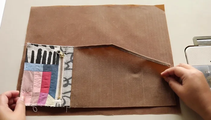 Attach zipper pouch to tool roll body: Attach the completed zipper pouch to the tool roll body, leaving space for a rolled hem.