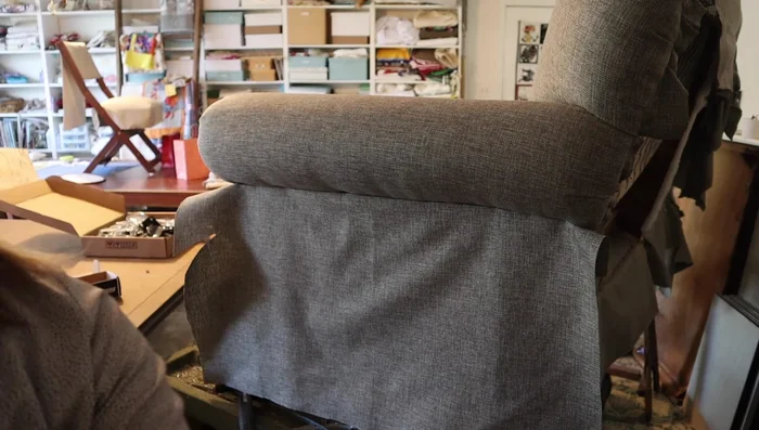 Secure the back using tack strip. Install a tack strip under the fabric to maintain a straight edge. Cover with Dacron for plumpness.