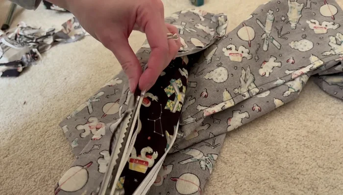 Finish the raw edges of the fabric near the zipper (using pinking shears or another method).