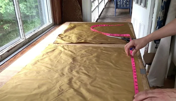 Shape fabric pieces to fit the chair's tapered form by marking and cutting to precise measurements.