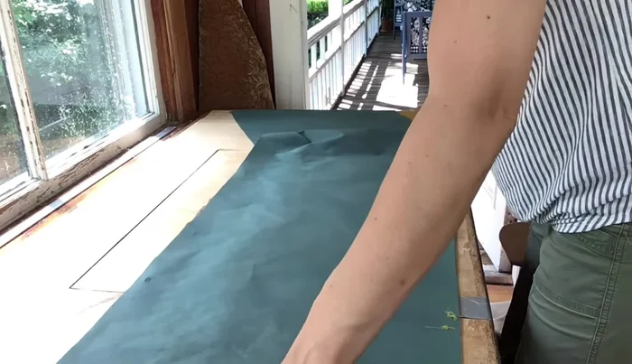 Fold the skirt and outside back panels, pressing to create neat corners. Ensure the main fabric is facing outwards, concealing the liner.