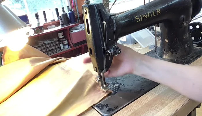 Fold the skirt and outside back panels, pressing to create neat corners. Ensure the main fabric is facing outwards, concealing the liner.