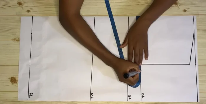 Mark your round bust measurement divided by four on the chest line. Use a curve to shape the armhole.