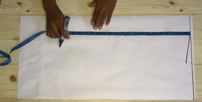 Mark your round bust measurement divided by four on the chest line. Use a curve to shape the armhole.