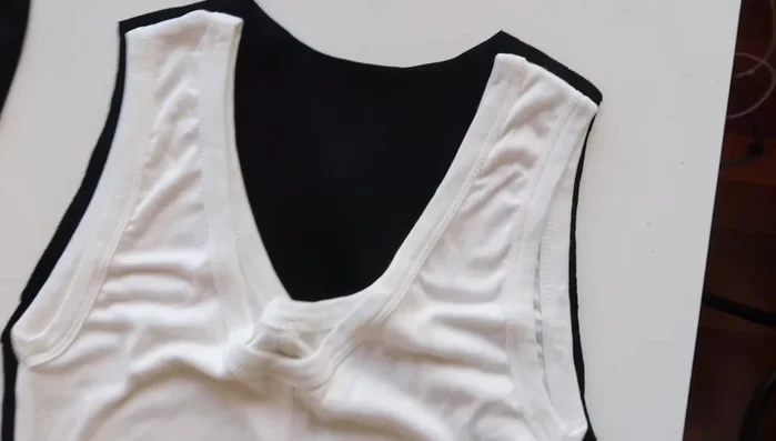 Cut the fabric: Cut out the front and back pieces, ensuring the neckline is higher in the back than in the front. Cut straight across the bottom.