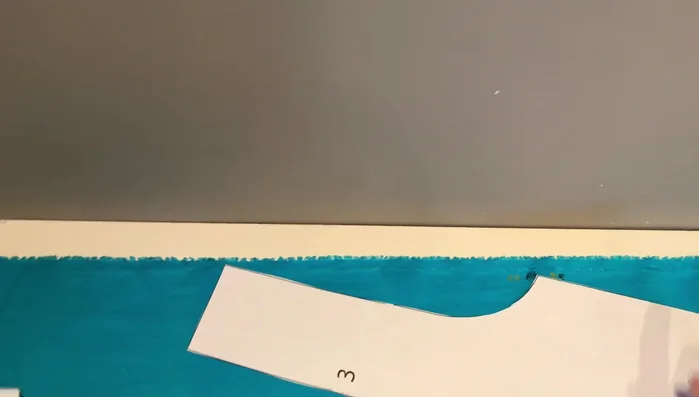 Measure and pin grain lines to ensure pattern pieces are parallel to the selvage and not overlapping. Pin the rest of the pattern pieces and cut them out.