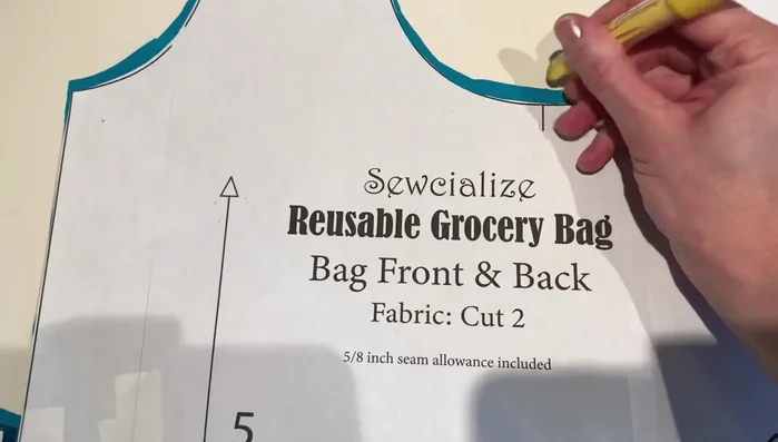 Pin the corners of the bag, matching seams. Sew across the short edge to give the bag dimension. Repeat for all four corners.