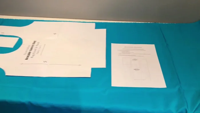 Measure and pin grain lines to ensure pattern pieces are parallel to the selvage and not overlapping. Pin the rest of the pattern pieces and cut them out.