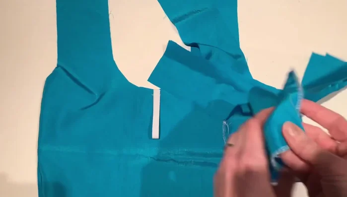 Press edges and sew the straps together, leaving an opening at the top. Turn under the seam allowance and press it flat.