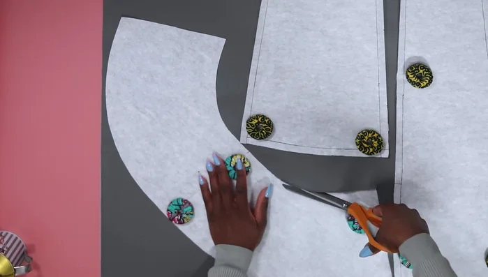 Cut the skirt pattern pieces using pattern weights to hold the fabric in place. Cut carefully with fabric scissors or rotary cutters.