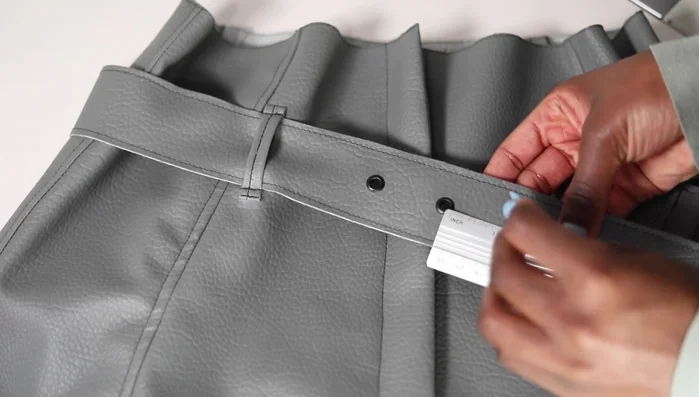 Attach eyelets to the belt using eyelet pliers.