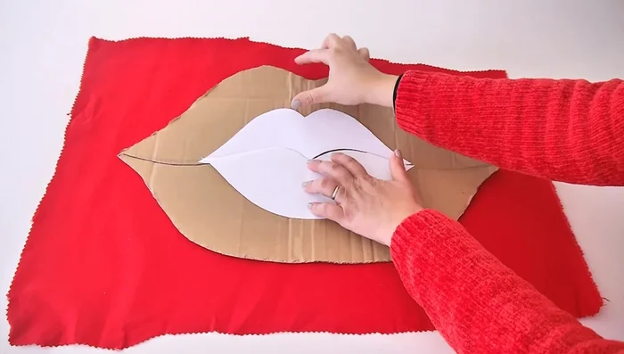 Cut out the fabric: Trace the enlarged cardboard template onto your fabric, leaving a 1-2cm/inch seam allowance. Cut out two identical lip shapes.