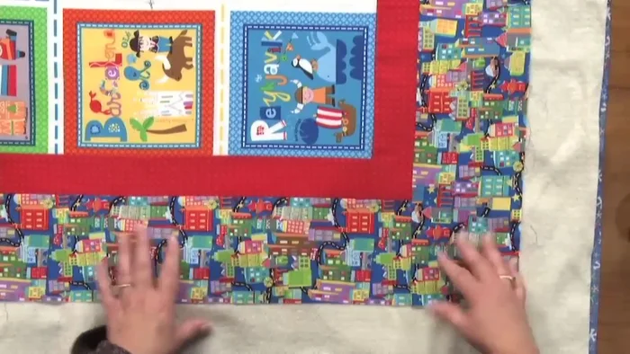 Pin the corners: Pin each corner, ensuring the border seams align diagonally. This ensures square corners.