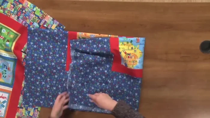 Fold and crease: Fold both the quilt top and backing in half lengthwise and widthwise, creating creases to mark the centers.