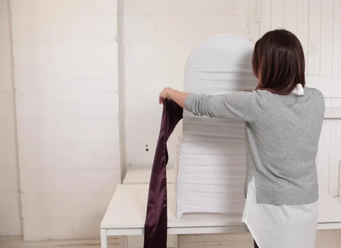 Wrap the sash around the front of the chair.