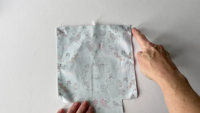 Make the box corners by pinning and sewing the seams together to create crisp corners. Repeat on the other side.