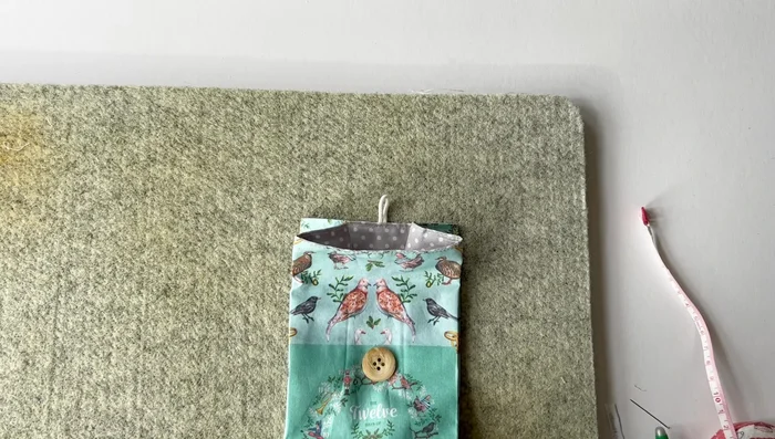 Fold the bag, loop the elastic over the button, and your fold-over bag is finished!