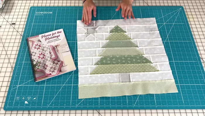 Cut and press all fabric pieces according to the pattern in the book.