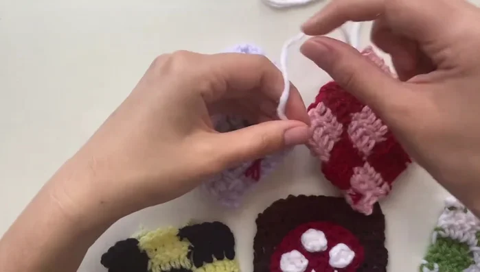 Continue sewing the panels together by alternating between the panels, securing stitches between them and tying off at the end. It's okay to adjust the stitches if they are uneven or spaced strangely.