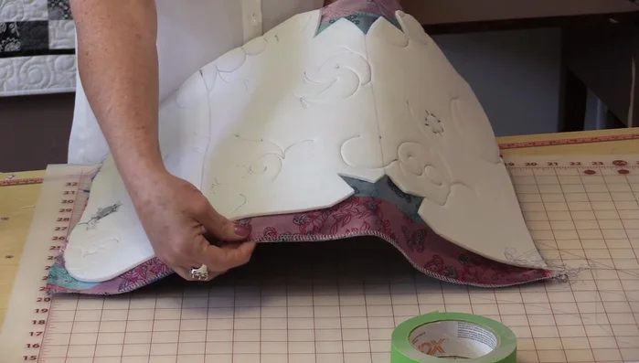 Zigzag stitch around the edges to secure the fabric and interfacing. Trim excess fabric after stitching.