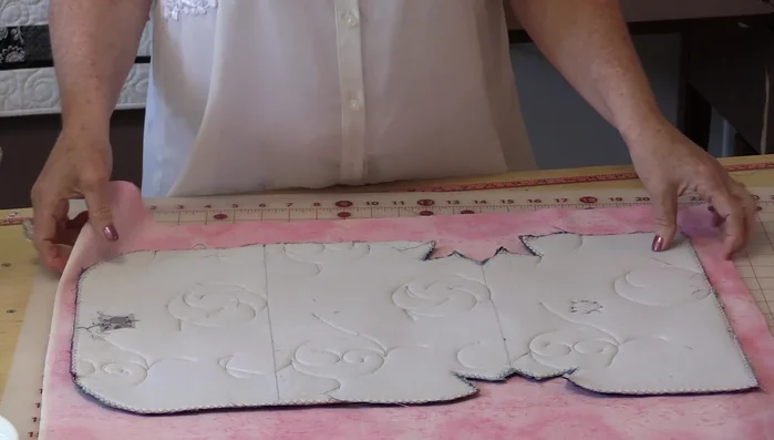 Sew the pocket to the lining, positioning it in the center. Ensure the pocket extends slightly beyond the lining's bottom, allowing it to seal when the flap is closed.