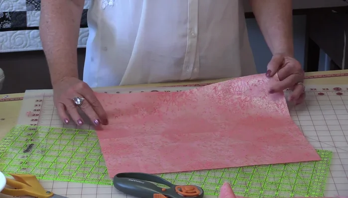 Sew the pocket to the lining, positioning it in the center. Ensure the pocket extends slightly beyond the lining's bottom, allowing it to seal when the flap is closed.