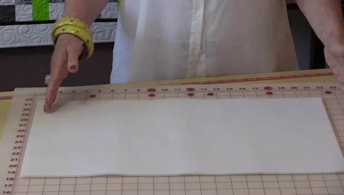 Add darts to the bottom corners of the bag body for shaping. Draw a 1-inch square in each corner, then draw a 45° angle line from the corner to a point on the square. Extend a line from the curve to 1.5 inches and connect it to the 1-inch mark.